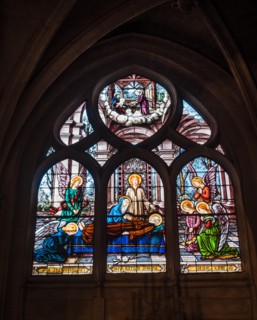 Paris, France - January 7, 2018: Beautiful stained glass window inside Notre Dame de Paris.