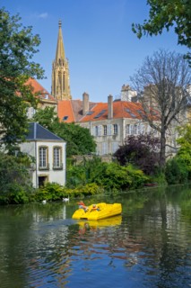 Paddle boat / pedal boat with tourists on the Moselle river in the city Metz, Moselle, Lorraine, France