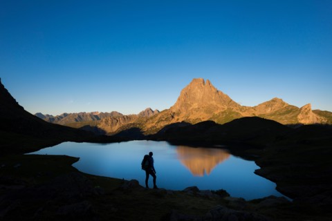 Taking in the view of Midi d'Ossau beyond Lac Gentau beside the GR10 trekking route in the French Pyrenees, Pyrenees Atlantiques, France, Europe