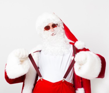 Cool Santa in red glasses holding his suspenders on white