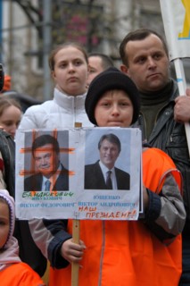 Orange revolution in Ukraine. Young boy dressed orange attends the demonstration of Ukrainian migrants in the Czech Republic to support Ukrainian oppositional presidential candidate Viktor Yushchenko ...