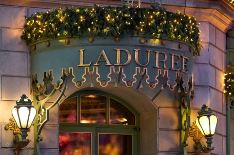 Laduree Champs Elysees. Beautifully lit, elegant entrance to the French luxury bakery and sweets maker house. PARIS, FRANCE - December 29, 2018