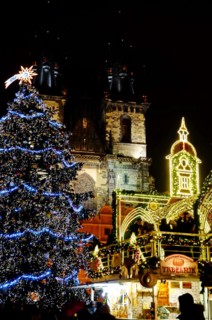 Christmas Prague at night. Glowing Christmas tree and beautiful decoration in front of Church of Our Lady before Týn on Old town square
