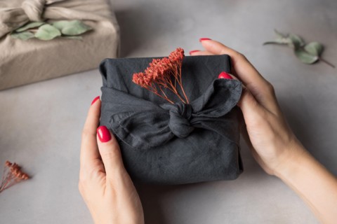 Female hands holding Furoshiki gift