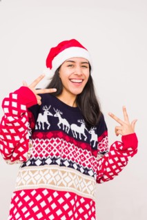Christmas ugly sweater. Latin venezuelan woman wearing a fashion woolen xmas style