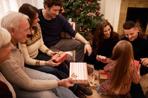 Enjoying a cosy family Christmas. a a family giving presents at christmas.