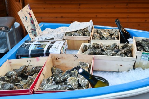 Oysters and champagne for sale at a Christmas market stand in Port Hercule, during the winter holidays, Monte Carlo, Principality of Monaco
