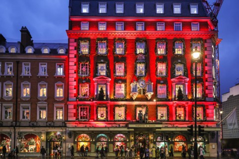 London, UK. 18th Nov, 2024. The annual 'advent calendar' facade decorations and 2024 display glows in festive red on the Fortnum and Mason building in Piccadilly. Christmas Lights, baubles and elabora...