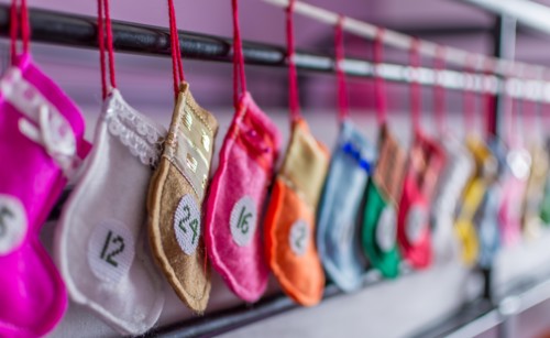 Handmade advent Christmas calendar of mini colorful Santa stockings