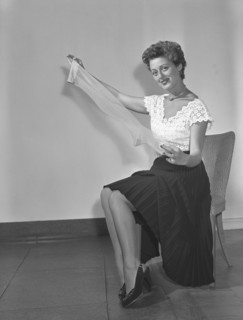 Nylon stockings in the 1940s. A young woman is holding a nylon stocking in her hands. The nylon stocking was very popular in the 1940s, a trendy accessory that was very expensive to buy during world w...