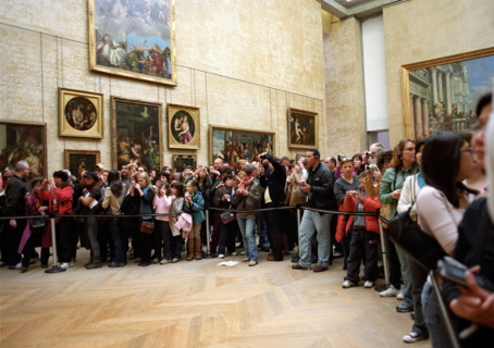 Tourists taking pictures of the Mona Lisa in The Louvre in Paris