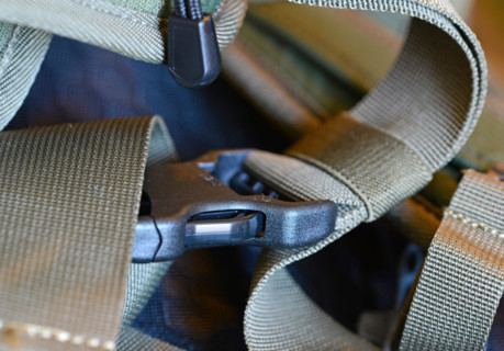 Closeup of nylon backpack with plastic straps, belts and clips