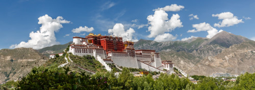 Panorama of Potala Palace, Tibet (China, Asia). Fantastic photo of the mighty palace of the Dalai Lama. Blue sky, clouds, extremly colorful.