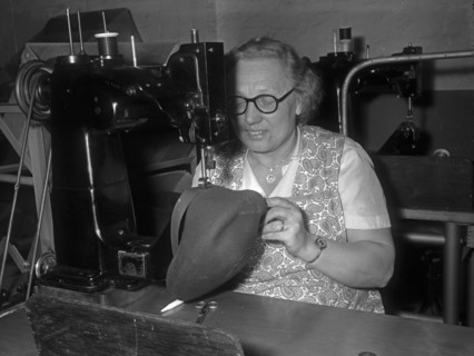 Seamstress sewing the inner band into a flat cap at the Denham and Hargreaves factory, Atherstone. Circa 1960