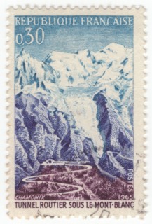FRANCE - 1965 July 17: An 30 centimes blue, violet-blue and brown-violet postage stamp depicting Road and tunnel, Mont Blanc. For the opening of the Mont Blanc Tunnel, a highway tunnel between France ...