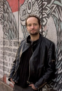 Jan 19, 2006; Mexico City, MEXICO; Mexican film maker, CARLOS REYGADAS' work is quintessentially Mexico City, here photographed in front of a decomposing mural on the streets of the historical center ...