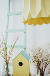 easter decoration. easter eggs with wooden feeder and mimosa.