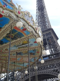 The eiffel tower in paris with the typical parisian carousel worth seeing at every season.