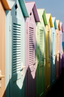 Group of colorful beach cabins in Italy.