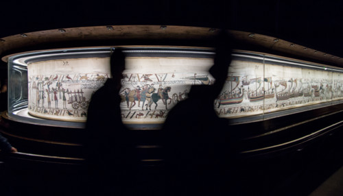 Bayeux, France. Tourists pass by the famous tapestry which depicts the events leading to the Norman conquest of England in 1066.
