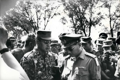Feb. 24, 2012 - Grief exchanged - Maj. General Suharto (left) newly appointed Army Chief of Staff in Indonesia, talks with fellow officer outside Army Headquarters in Djakarta prior to funeral service...
