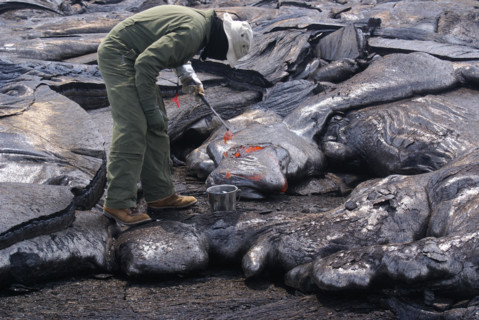 A volcanologist collects lava samples at Hawaii Volcanoes National Park, part of the U.S. Geological Survey’s ongoing research into volcanic activity. The park is home to Kilauea, one of the world’s m...