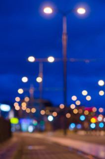 Blurred image of night city street with lamppost lights