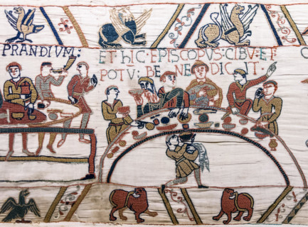 Scene 43 of the Bayeux Tapestry depicts a banquet, possibly celebrating William the Conqueror's victory. The embroidery illustrates medieval dining customs, with figures feasting at a table, emphasizi...