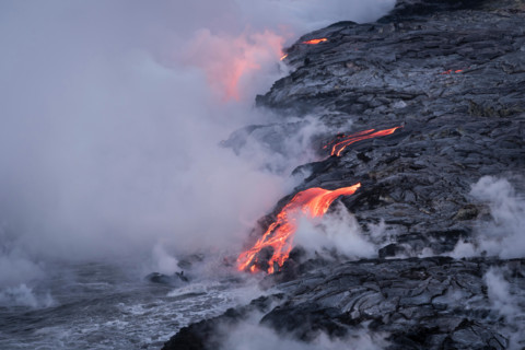 Lava from Pu'u O'o eruption entering the ocean; Hawaii Volcanoes National Park, Island of Hawaii.