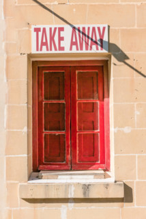 Red window and shutters with a sign above saying "Take Away"