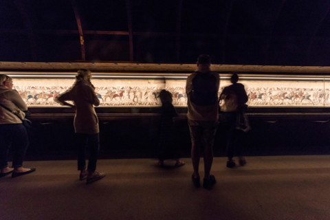 Bayeux, France. Visitorswalk past the famous tapestry (Tapisserie) of Bayeux,1000 year old carpet telling the story of the Norman conquest of England