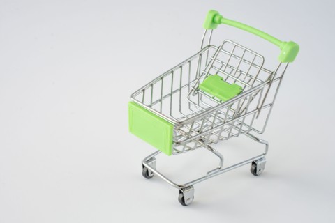 Small shopping cart on gray background. shopping concept. space for text