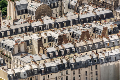 Aerial view of haussmanian buildings, traditional zinc roofs and chimneys in Paris, France