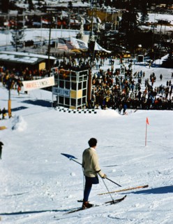 1960 Winter Olympics in Squaw Valley California: One legged skier watching skiers on the slalom course