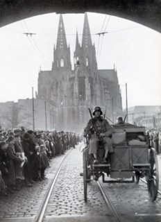 A photograph shows German troops crossing the Rhine into the Rhineland on March 7, 1936. This event marked a critical moment in Nazi Germany's aggressive expansion, as it violated the Treaty of Versai...