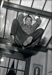 Aug. 17, 1960 - Darry Cowl is pictured in a funny scene in which he hangs from the ceiling in Jacques Poitrenaud's movie ''Paris Loves'