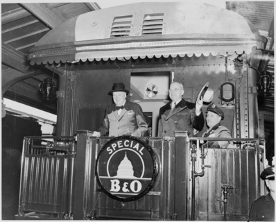 Photograph of President Truman and Prime Minister Churchill standing on the rear platform of a special Baltimore & Ohio train (evidently en route to Fulton, Missouri for Churchill's Iron Curtain Speec...