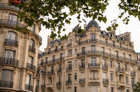 Eiffel tower between Parisian tenement old street alley and buildings, Paris