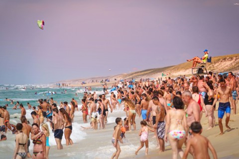 Overcrowded beach on atlantic ocean in a summer day. Lacanau, France - August 2018