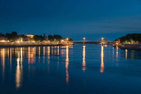 Night panoramic view of the French city, Arles on the River Rhône at night.