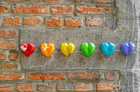 Rainbow flag decoration on brick wall, pride month concept