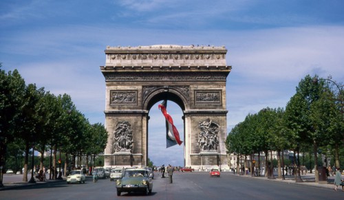 The Arc de Triomphe, summer 1963, with a huge French flag flying underneath it. Holiday in France. Vacances en France