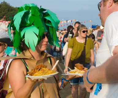 A woman with a plate of food at Bestival on the Isle of Wight