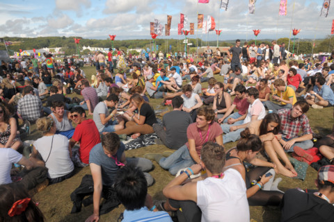 Crowds of music fans at the 2011 Bestival music festival pop concert on the Isle of Wight, England.