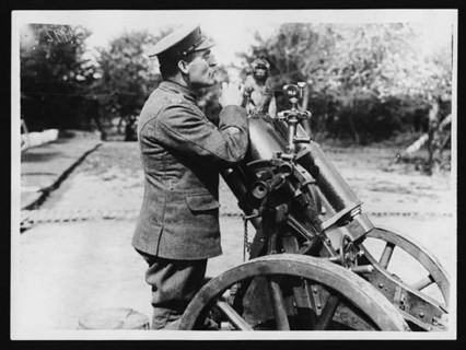 A mascot of the trench mortar school posed on a German trench mortar during World War I. Trench mortars were essential in targeting enemy positions on the front lines.
