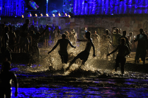 People having fun in the mud pool of the Przystanek Woodstock Music festival in Kostrzyn, Poland.