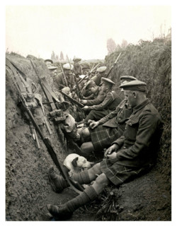 Historic image of WW1 Highland territorials and their mascot dog wait to 'go over the top' in a trench in Northern France