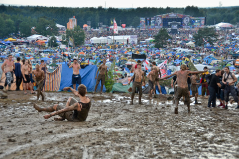 KOSTRZYN NAD ODRA, POLAND - AUGUST 4: Festival Przystanek Woodstock - fans bath in the mud in front camping  on August 4, 2012 i