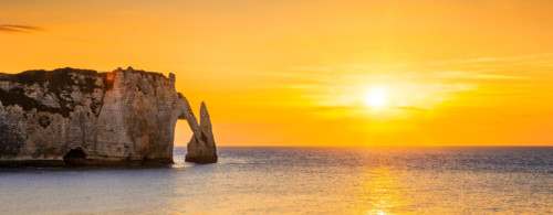 Panoramic view of Etretat Aval cliff at sunset