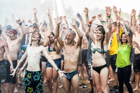 People enjoying water curtain at the19th Przystanek Woodstock (Woodstock Festival).